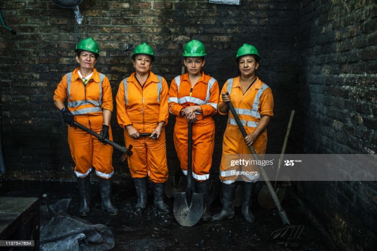 Women miners stand for a photograph at the washing plant of