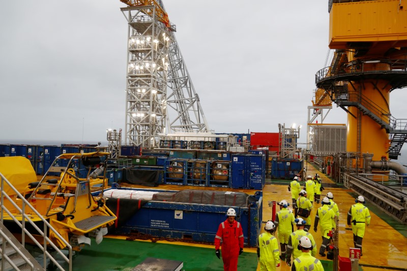 People walk on the Equinor's Johan Sverdrup oilfield platform in the North Sea