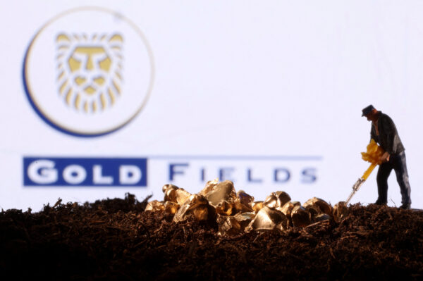 FILE PHOTO: Small toy figure and gold imitation are seen in front of the Gold Fields logo in this illustration