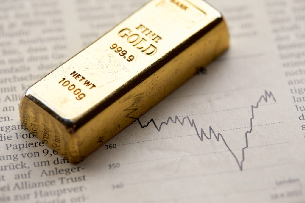 Gold bullion  on the graph as crisis safe haven, financial asset, investment and wealth concept...