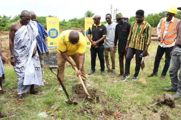Mr. William Tetteh Chief Transformation Officer breaking ground for the construction of a shed for women in pottery