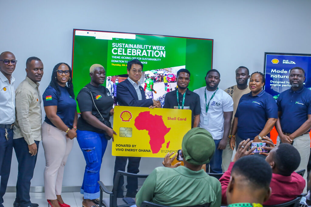 Mr. Christian Li, Managing Director of Vivo Energy Ghana PLC Presenting a Dummy Shell card to the Buz Stop Boys.