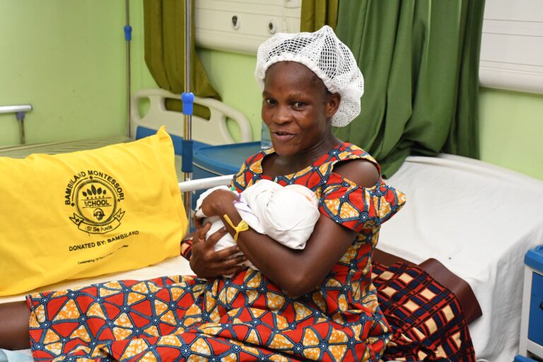 A mother cradles her newborn at the MTN Ghana Foundation-funded Maternity and Child Health Block Keta Municipal Hospital,